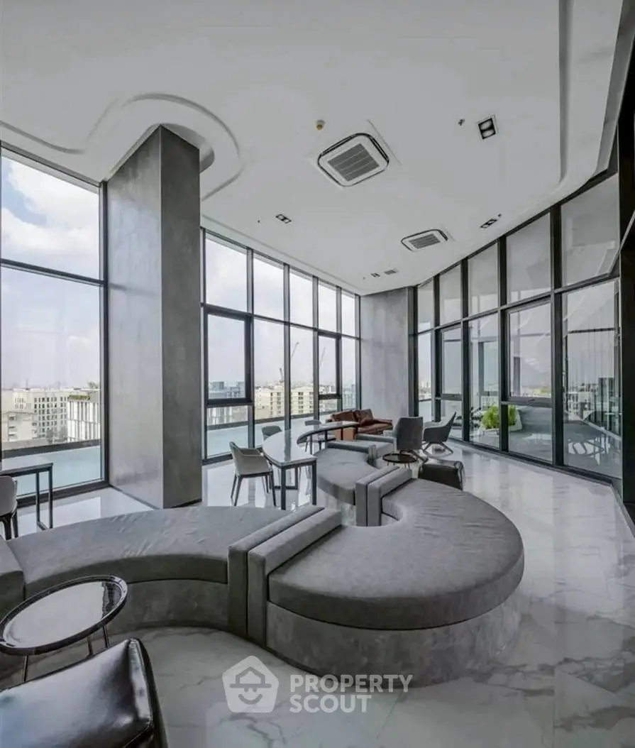 Luxurious modern living room with panoramic city views and stylish curved seating.