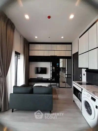 Modern living room with sleek design and in-unit washing machine