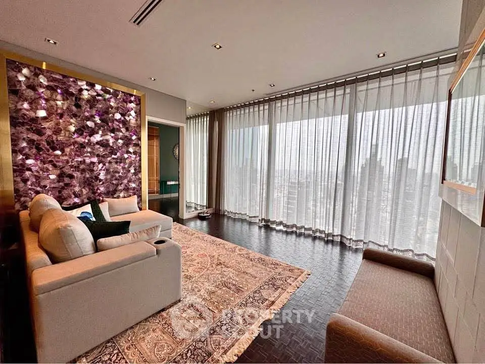 Luxurious living room with floor-to-ceiling windows and elegant decor in a high-rise apartment.