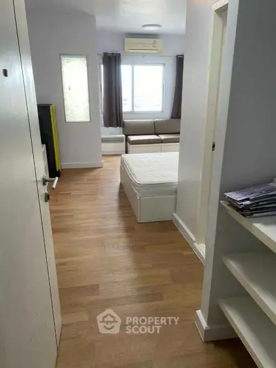 Cozy studio apartment with wooden flooring and natural light