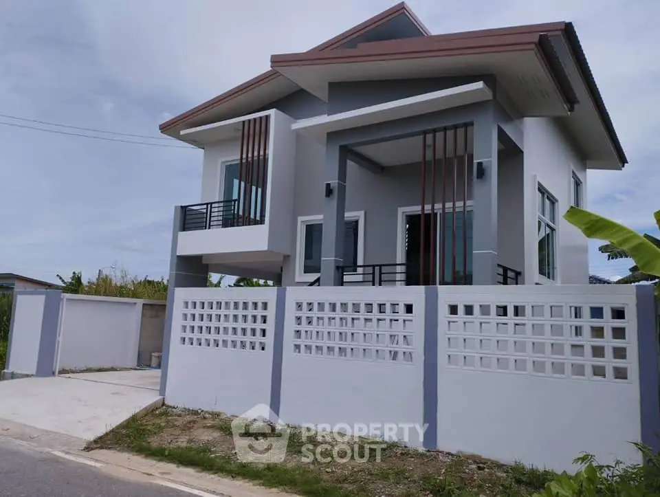 Modern two-story house with unique architectural design and spacious driveway.