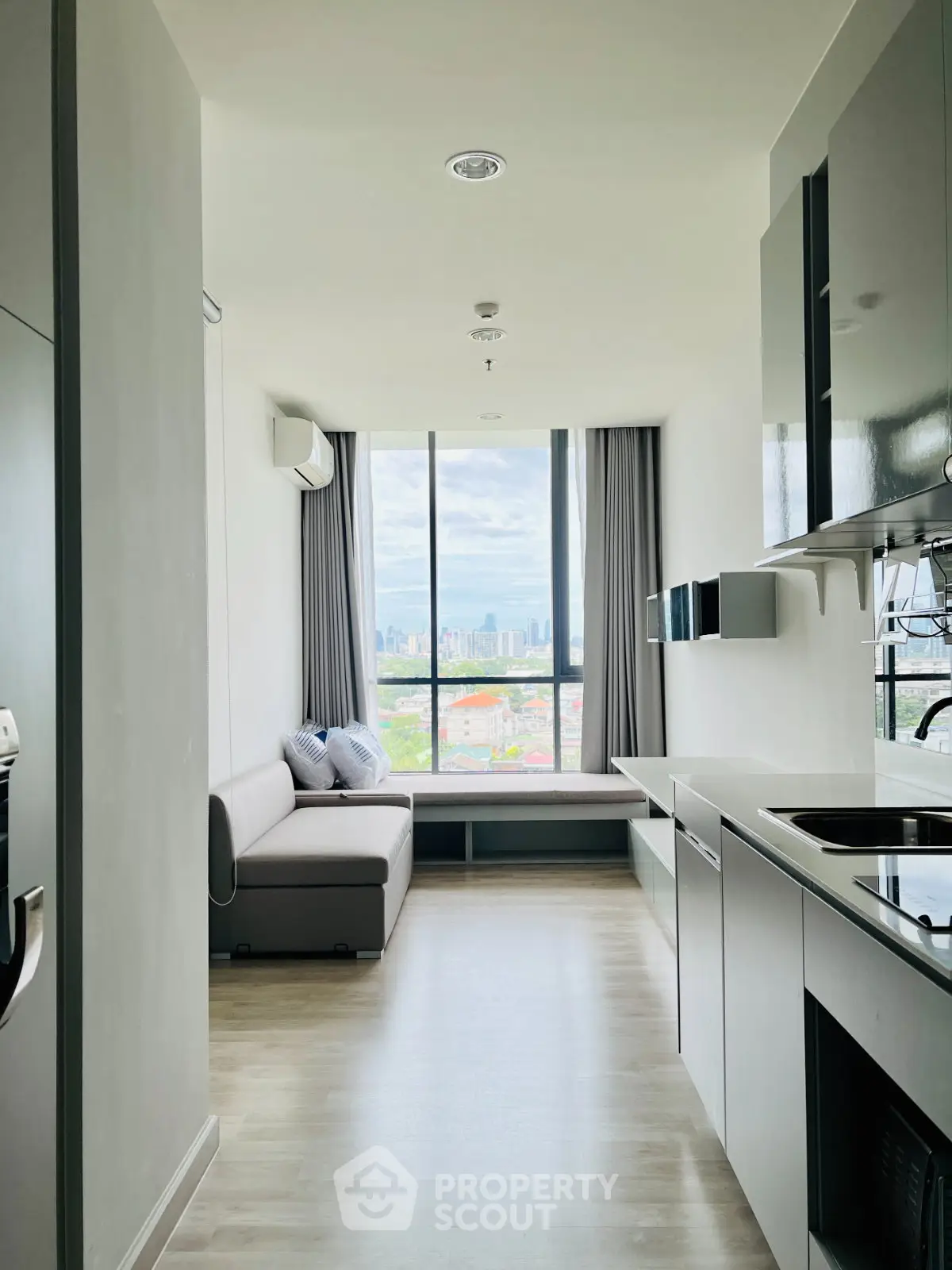 Modern apartment interior with open kitchen and stunning city view