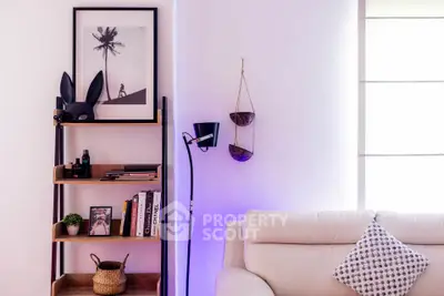 Stylish living room with modern decor, featuring a cozy white sofa, unique shelving, and ambient lighting.