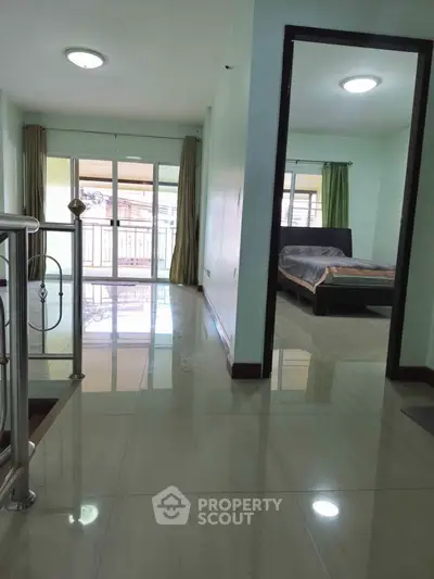 Spacious modern interior with bedroom and balcony view, perfect for comfortable living.