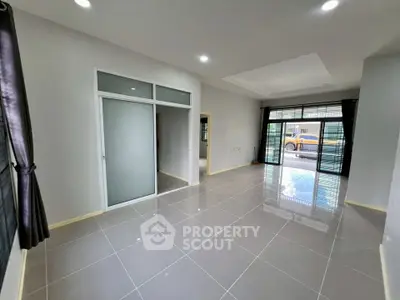 Spacious modern living room with large windows and sleek tile flooring