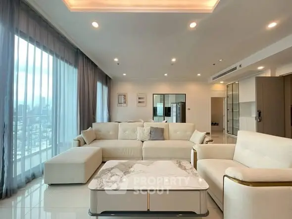 Luxurious modern living room with large windows and elegant furniture.