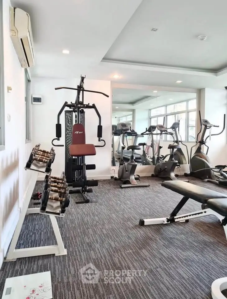 Modern gym with state-of-the-art fitness equipment in a residential building.