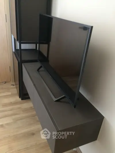 Modern living room with sleek TV and stylish furniture
