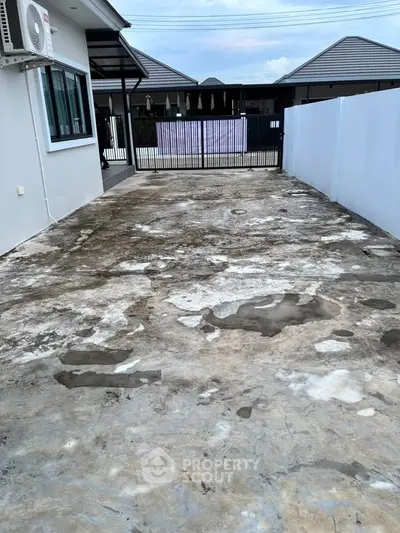 Spacious driveway with potential for customization in modern residential area.