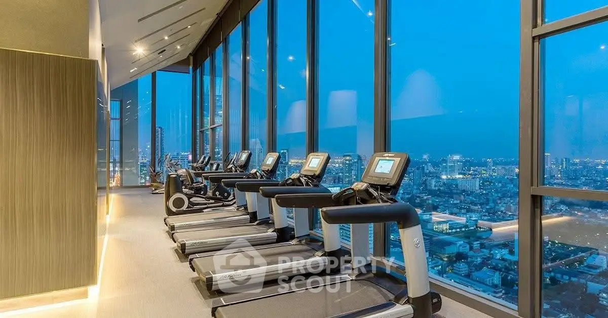 Luxurious high-rise gym with panoramic city views and modern equipment.