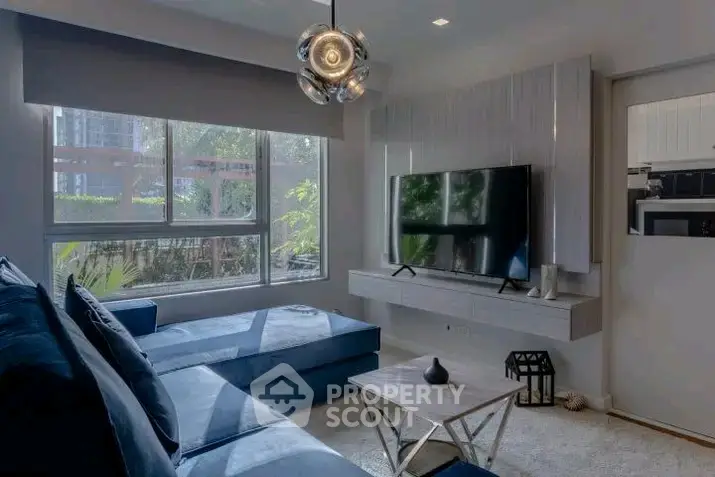 Modern living room with sleek design, large windows, and stylish furniture for a cozy ambiance.