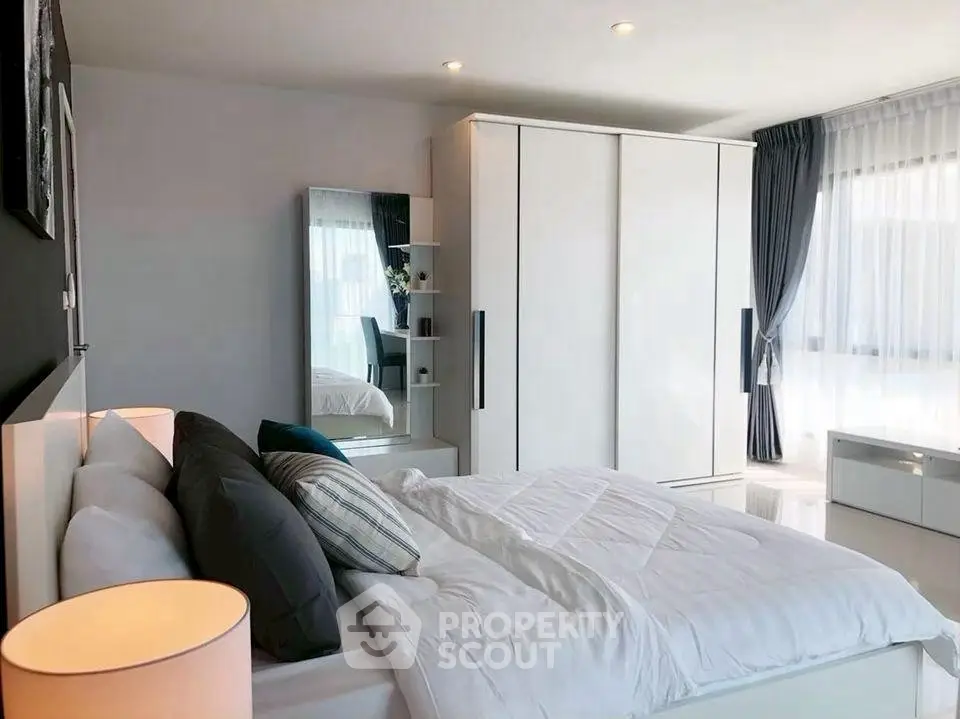 Spacious modern bedroom with large windows and stylish decor