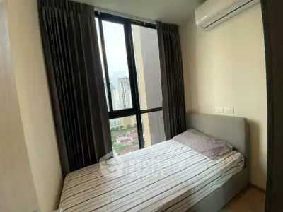 Cozy bedroom with city view and air conditioning in modern apartment