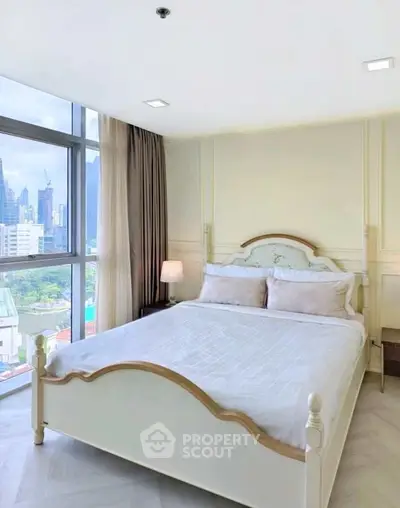 Bright and airy bedroom with city view, featuring elegant bed and large windows.