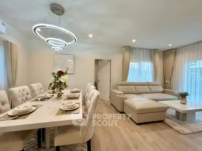 Luxurious open-plan living and dining area with elegant decor and modern lighting.