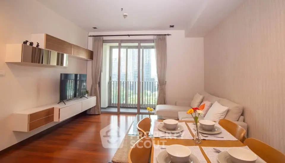 Modern living room with dining area and balcony view in a stylish apartment.