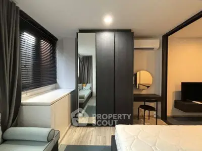 Modern bedroom with sleek furniture and large mirror wardrobe