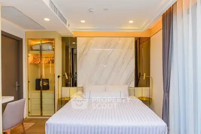 Luxurious bedroom with elegant decor and modern furnishings in a stylish apartment.