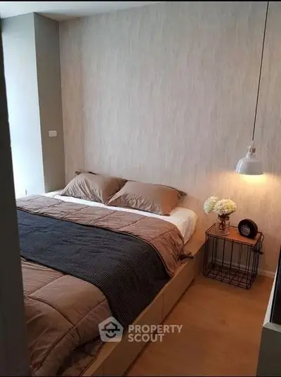 Cozy bedroom with modern decor and soft lighting, perfect for relaxation.