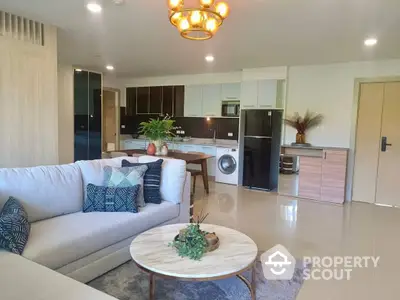 Spacious open-plan living area with modern kitchen, elegant furnishings, and sleek appliances, perfect for entertaining and comfortable living.