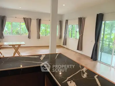 Spacious living room with large windows and elegant marble countertop