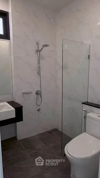 Modern bathroom with sleek design and glass shower partition