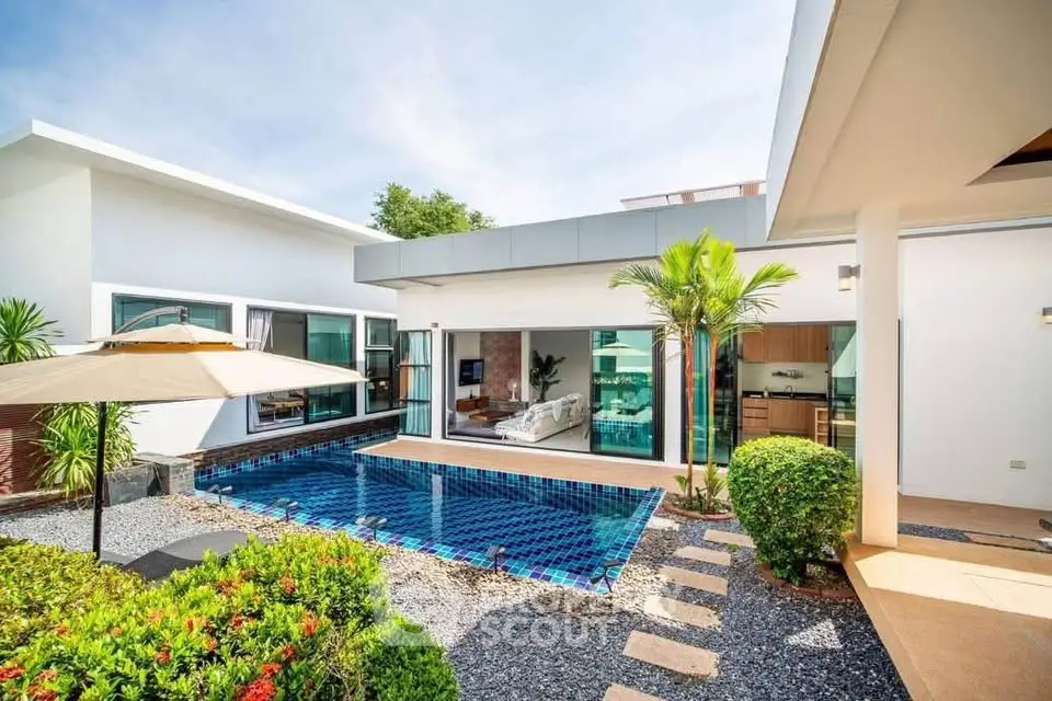 Luxurious modern villa with private pool and lush garden, perfect for serene living.