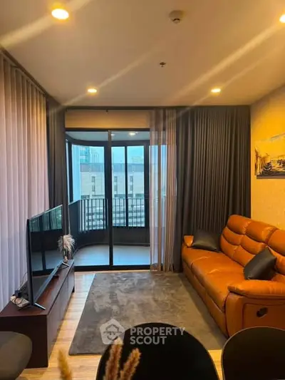 Modern living room with leather sofa and balcony view in a stylish apartment.