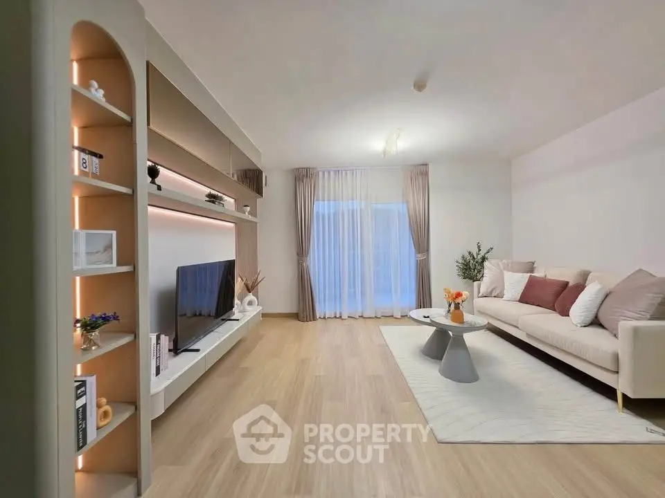 Spacious modern living room with stylish decor and large TV unit