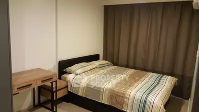 Cozy bedroom with modern furniture and elegant curtains, perfect for relaxation.