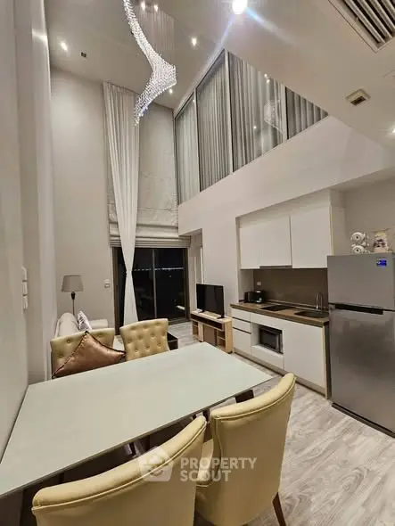 Luxurious modern living room with high ceilings and elegant chandelier in a stylish apartment.