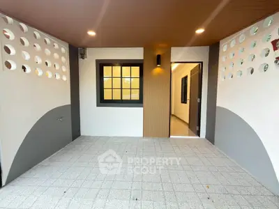 Modern covered patio with stylish wall design and recessed lighting