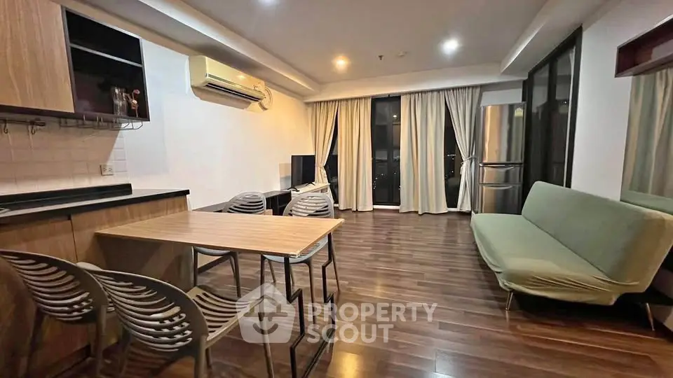 Modern living room with sleek furniture and wooden flooring in a stylish apartment.
