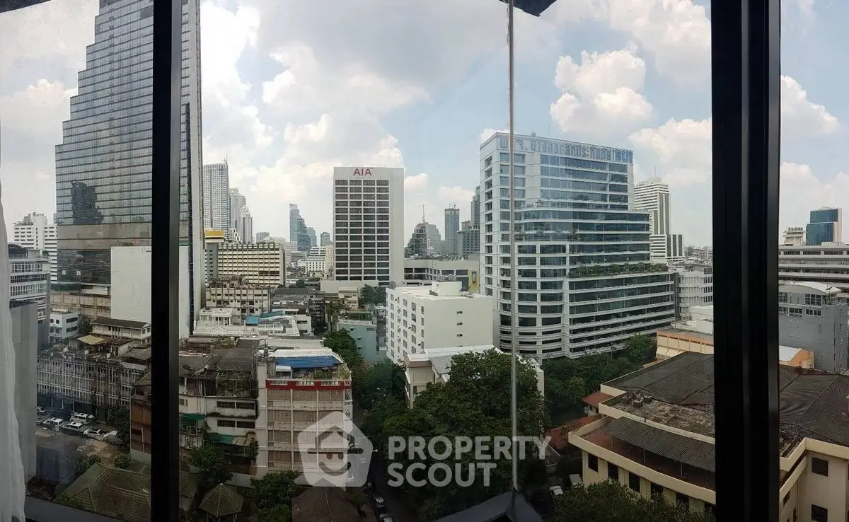 Stunning cityscape view from high-rise building window showcasing urban skyline.