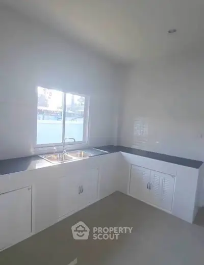 Bright kitchen with dual sink and ample counter space