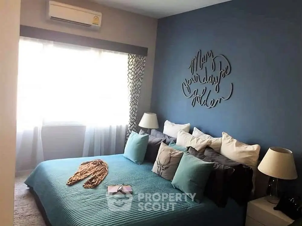 Cozy bedroom with blue accent wall and stylish decor