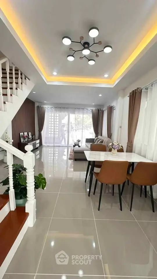 Spacious modern living room with elegant dining area and stylish lighting
