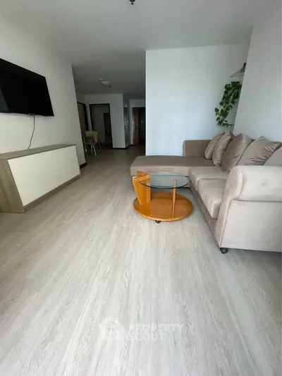 Spacious living room with modern decor and sleek wooden flooring