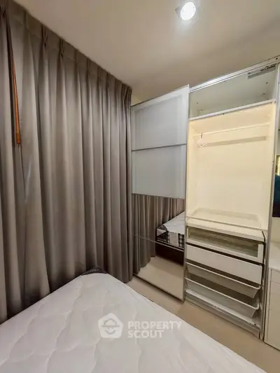 Cozy bedroom with built-in wardrobe and elegant curtains