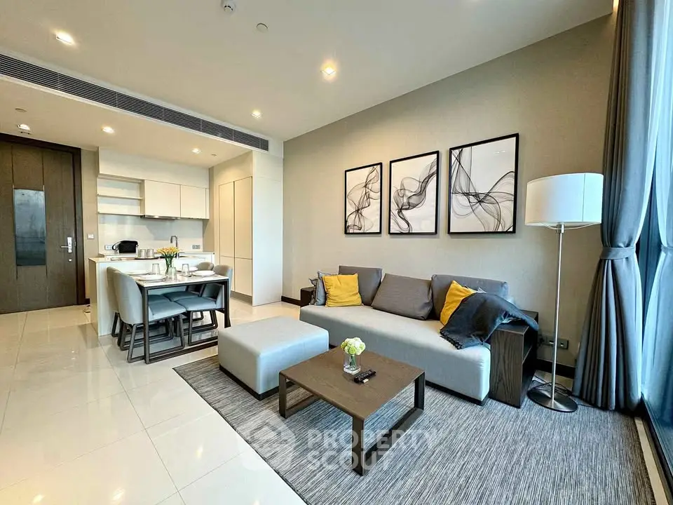 Modern open-layout living room with stylish decor and kitchen area, featuring elegant furniture and large windows.