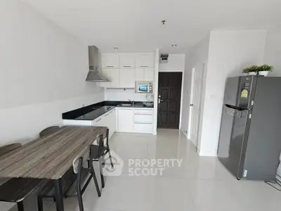 Modern kitchen with sleek design and dining area in a bright apartment