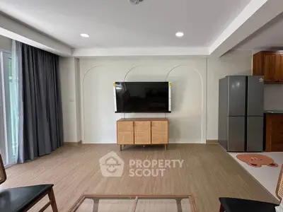 Modern living room with wall-mounted TV and sleek furniture
