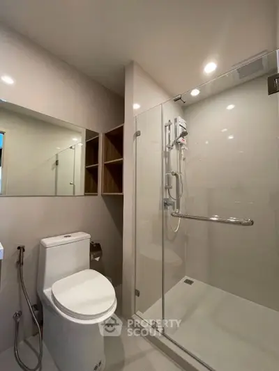 Modern bathroom with glass shower enclosure and sleek fixtures