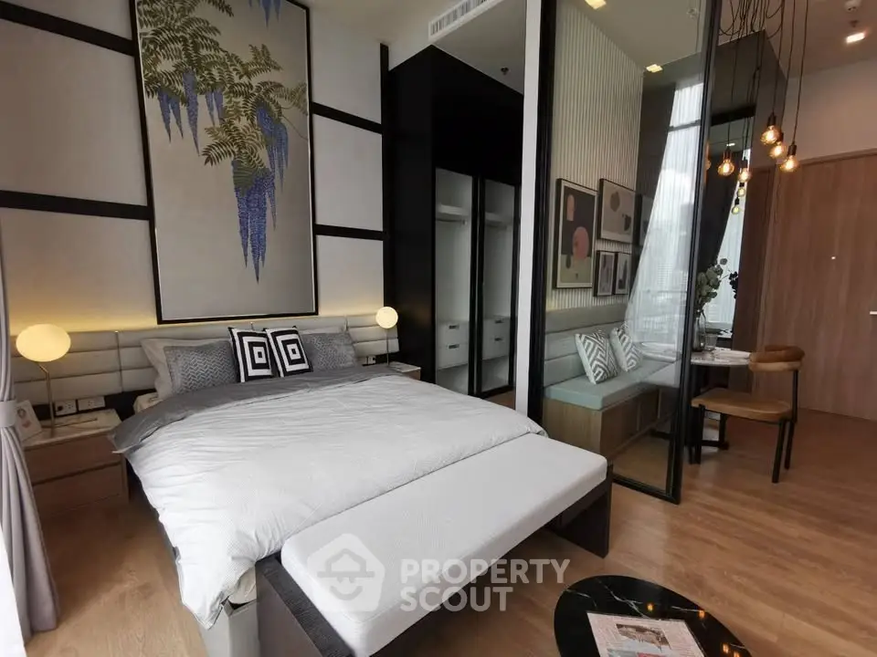 Luxurious modern bedroom with elegant decor and cozy seating area, perfect for relaxation and comfort.