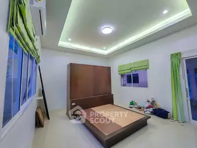 Spacious bedroom with modern design and ambient lighting, featuring large windows and minimalist decor.