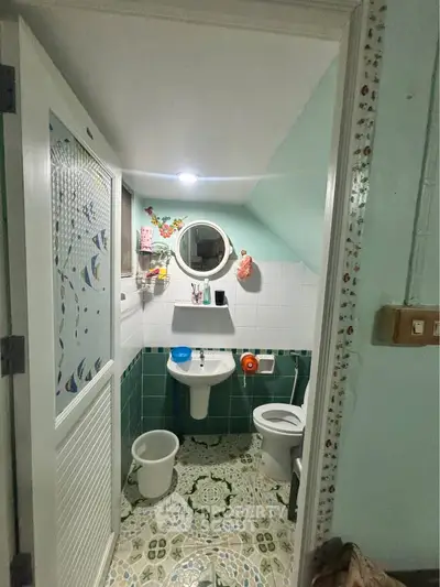 Charming small bathroom with unique tile design and compact layout, perfect for cozy living spaces.