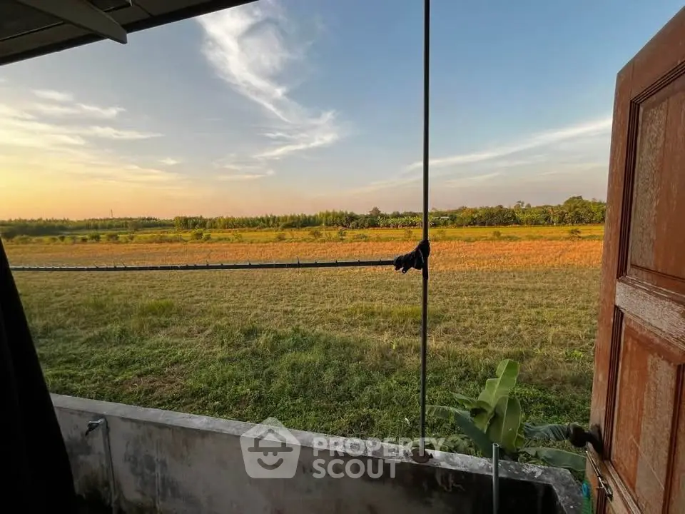 Stunning countryside view from a balcony at sunset, perfect for nature lovers.