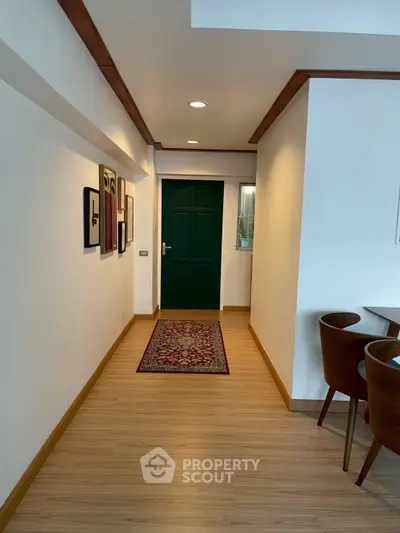 Stylish apartment hallway with wooden flooring and elegant decor