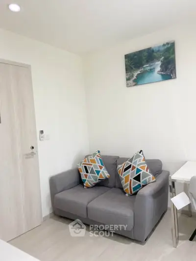Cozy living room with modern decor and comfortable seating in a stylish apartment.