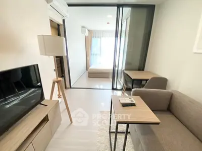 Modern living room with sleek furniture and natural light in a stylish apartment.